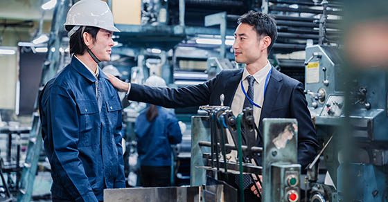 Two men standing in a manufacturing plant